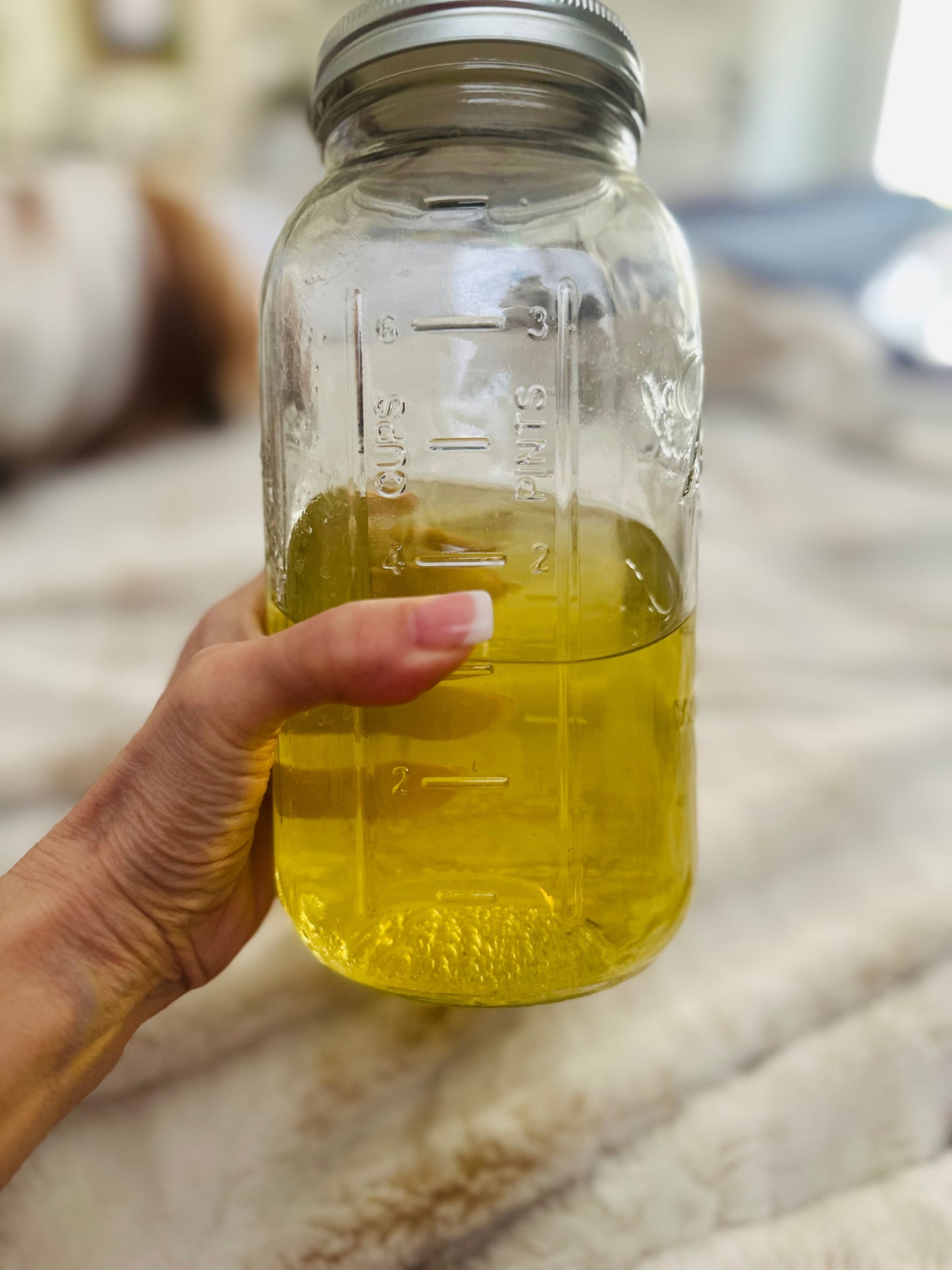 Pure gold lavender essential oil in glass, fresh from the copper still — Central Coast Lavender, Paso Robles