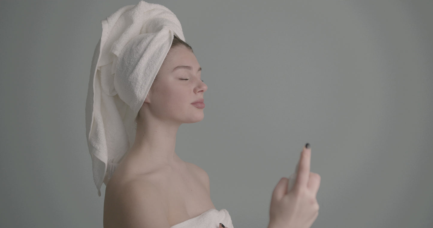 Load and play video in Gallery viewer, Woman misting face with towel
