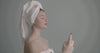 Woman misting face with towel
