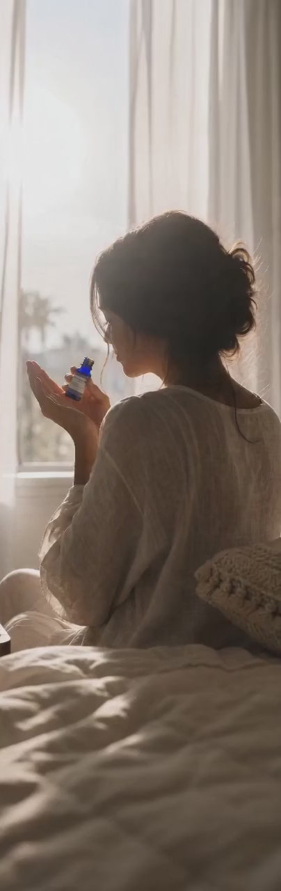 Woman smelling EO at window